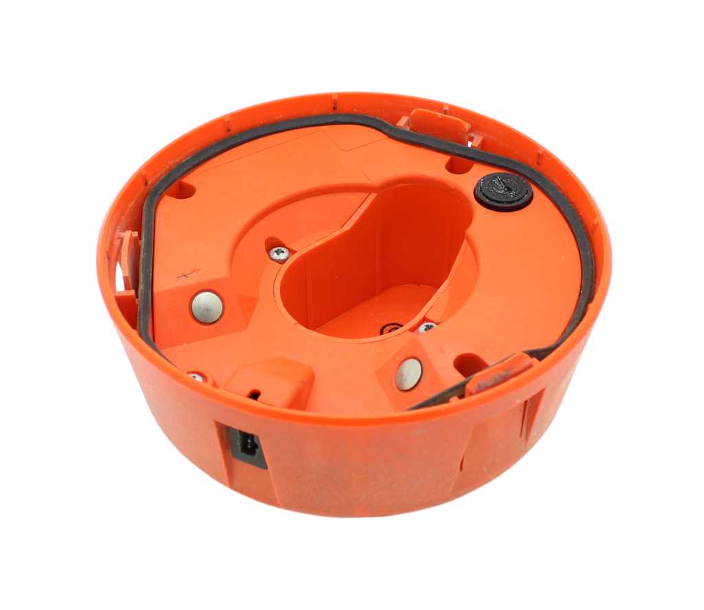Rundes orangefarbenes Kunststoffgehäuse mit Dichtung, zentraler Aussparung, Schrauben und Kontaktflächen in der Innenansicht