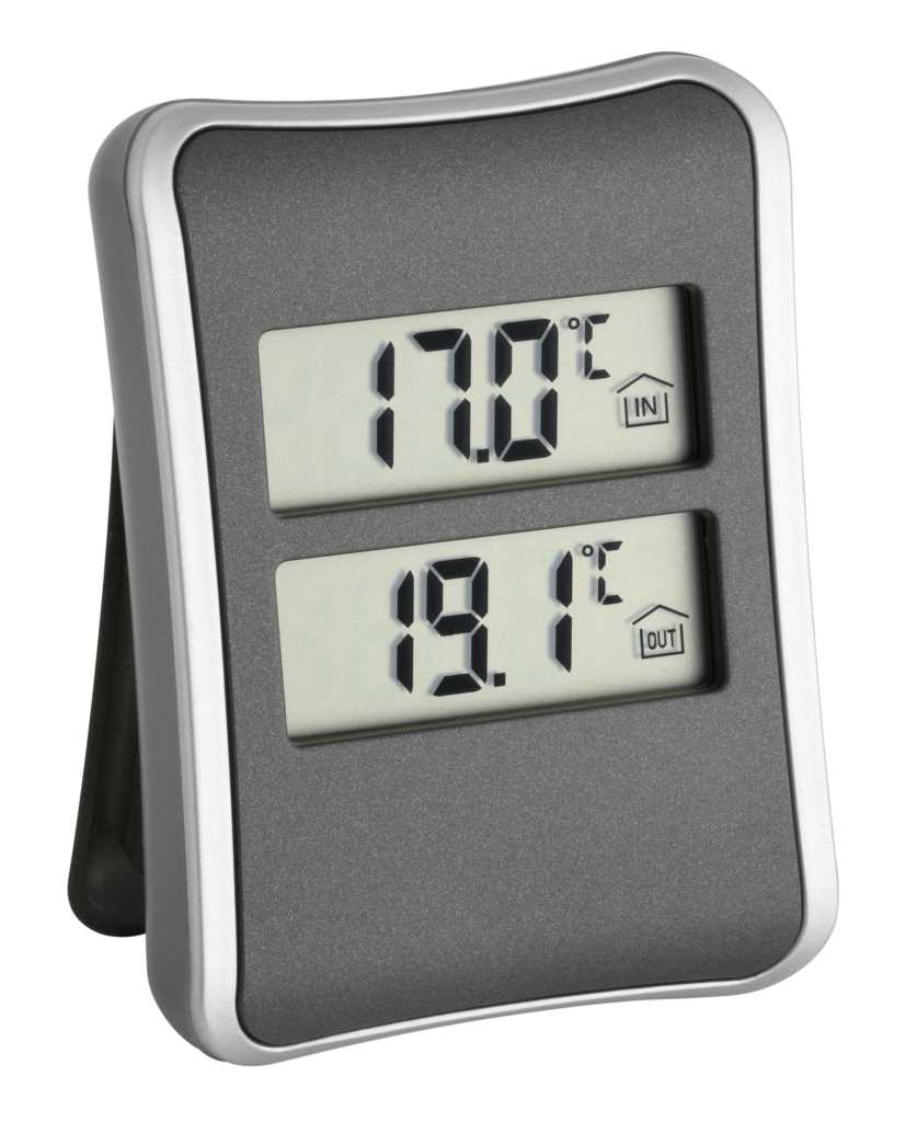 Graues Digitalthermometer mit zwei Displays für Innen- und Außentemperatur, aufgestellt auf weißem Hintergrund