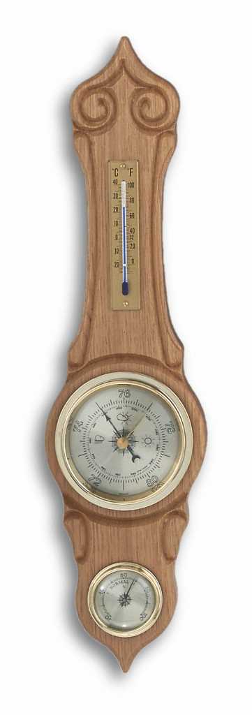 Holzleiste mit Schnitzornamenten, oben Thermometer und darunter zwei runde Skalen mit Zeigern